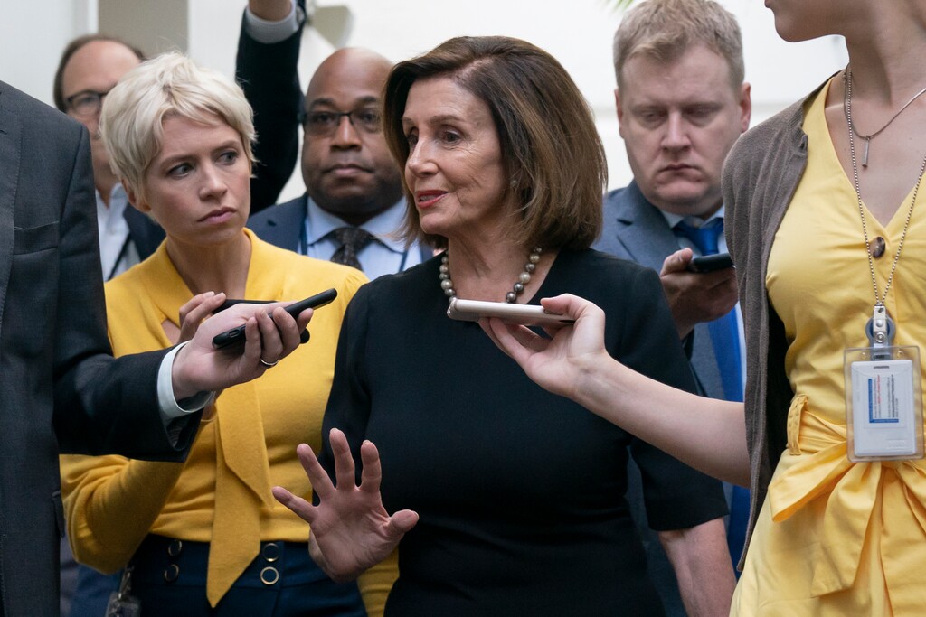 (J. Scott Applewhite | AP) Speaker of the House Nancy Pelosi, D-Calif., is surrounded by reporters as she arrives to meet with her caucus the morning after declaring she will launch a formal impeachment inquiry against President Donald Trump, at the Capitol in Washington, Wednesday, Sept. 25, 2019.