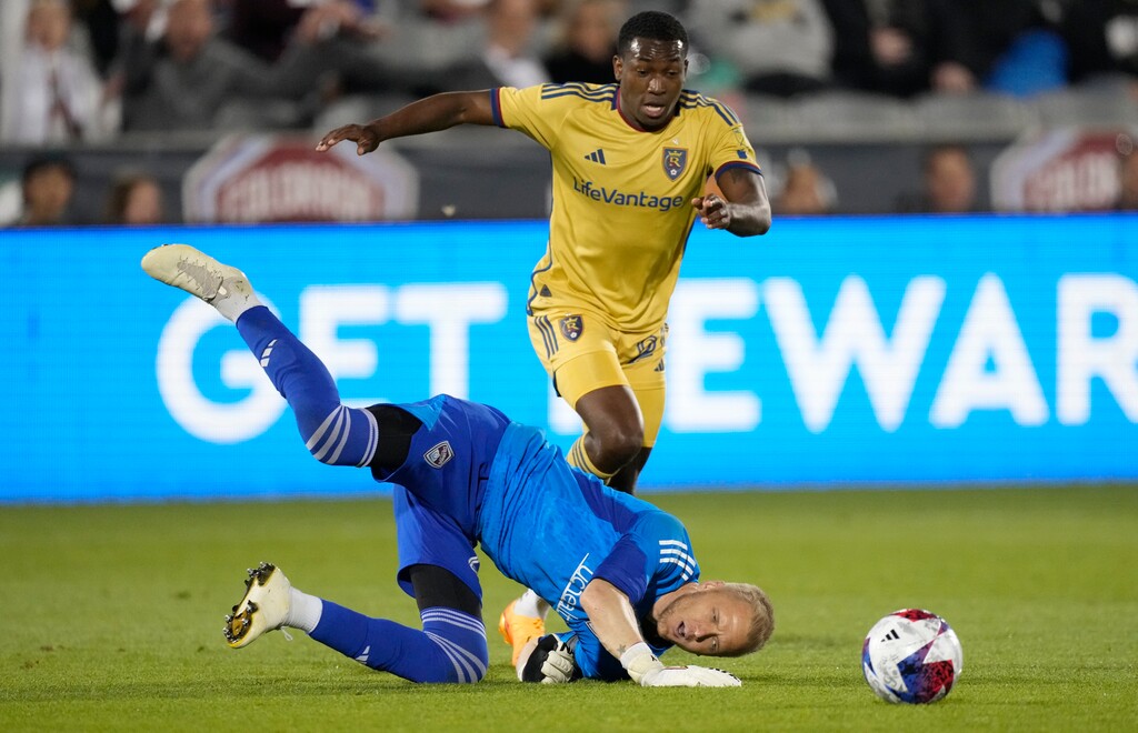 Colorado Rapids goalkeeper William Yarbrough, front, tumbles to the pitch after stopping a shot by Real Salt Lake midfielder Anderson Julio in the second half of an MLS soccer match Saturday, May 20, 2023, in Commerce City, Colo. (AP Photo/David Zalubowski)