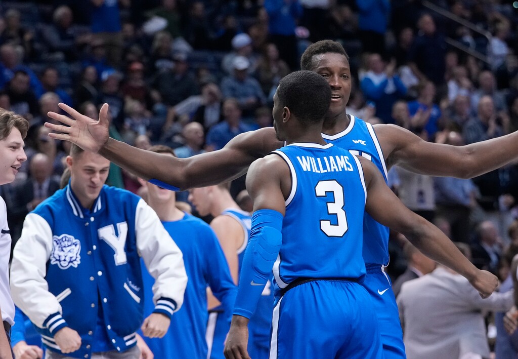 (Leah Hogsten | The Salt Lake Tribune) Brigham Young Cougars guard Rudi Williams (3) is celebrated during a timeout as Brigham Young University hosts University of Utah in Provo, Dec. 17, 2022. 