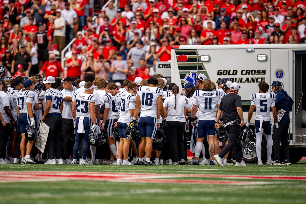 (Trent Nelson  |  The Salt Lake Tribune) Utah State players surround Utah State Aggies linebacker Harrison Taggart (0) as he's taken off the field as Utah hosts Utah State, NCAA football in Salt Lake City on Thursday, Sept. 17, 2026.