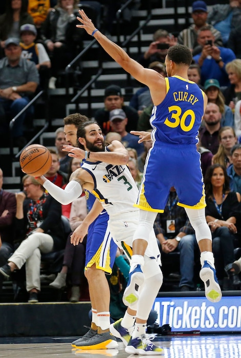 Golden State Warriors guard Stephen Curry (30) guards against Utah Jazz guard Ricky Rubio (3) in the first half during an NBA basketball game Friday, Oct. 19, 2018, in Salt Lake City. (AP Photo/Rick Bowmer)