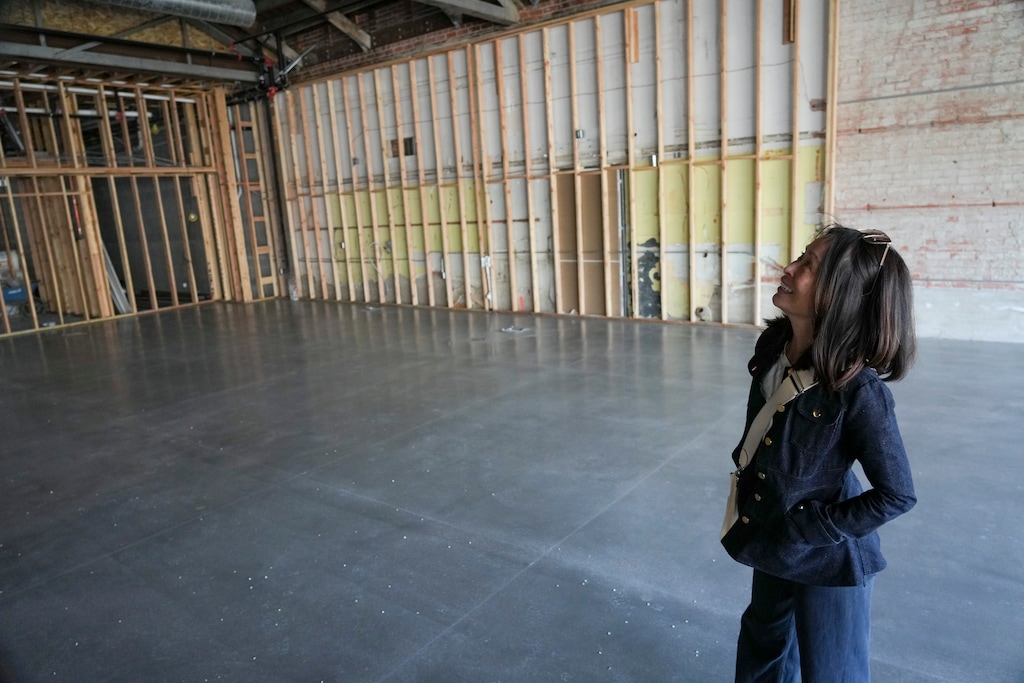 (Bethany Baker | The Salt Lake Tribune) Developer Kathia Dang walks through the inside of a building being renovated on here Milk Block development, in the 400 East block of 900 South in Salt Lake City, on Tuesday, April 22, 2025.