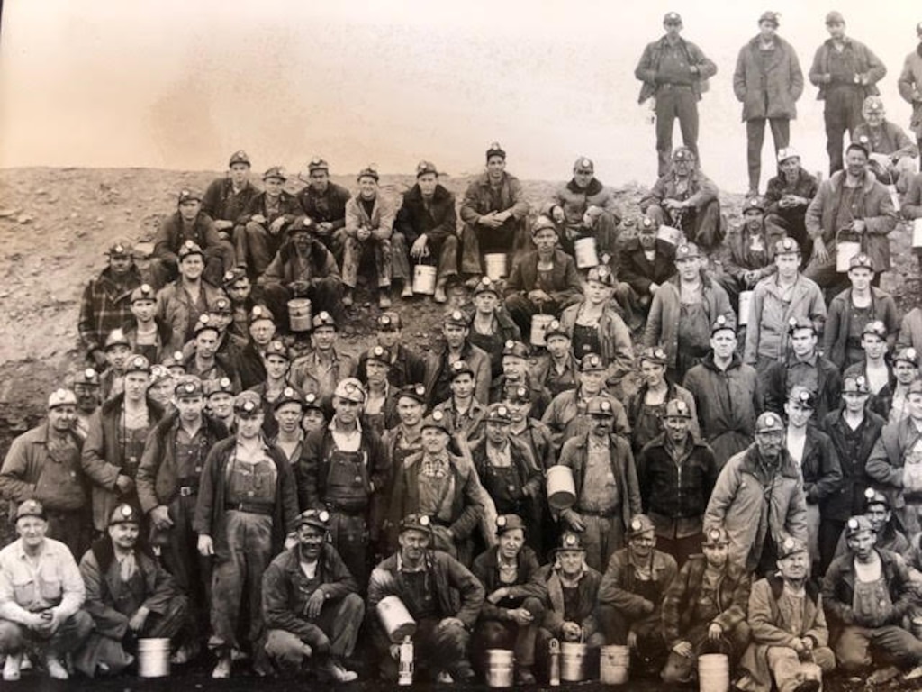 Coal miners of the #4 mine in Rock Springs, Wyoming, circa late '30s-early '40s. The author's father, Albert, is fifth from left of crouching miners in front.
