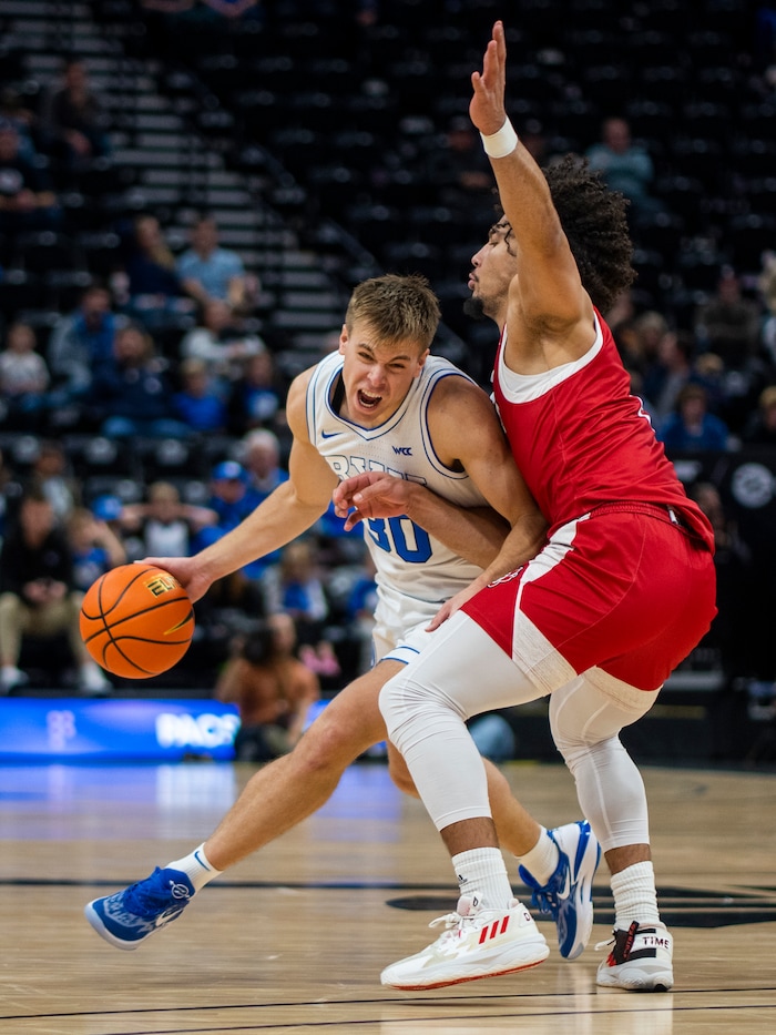 (Rick Egan | The Salt Lake Tribune)  Brigham Young Cougars guard Dallin Hall (30) tries to get past South Dakota Coyotes guard Damani Hayes (2), in basketball action between the Brigham Young Cougars and the South Dakota Coyotes, at Vivint Arena, in Salt Lake City, on Saturday, Dec. 3, 2022.
