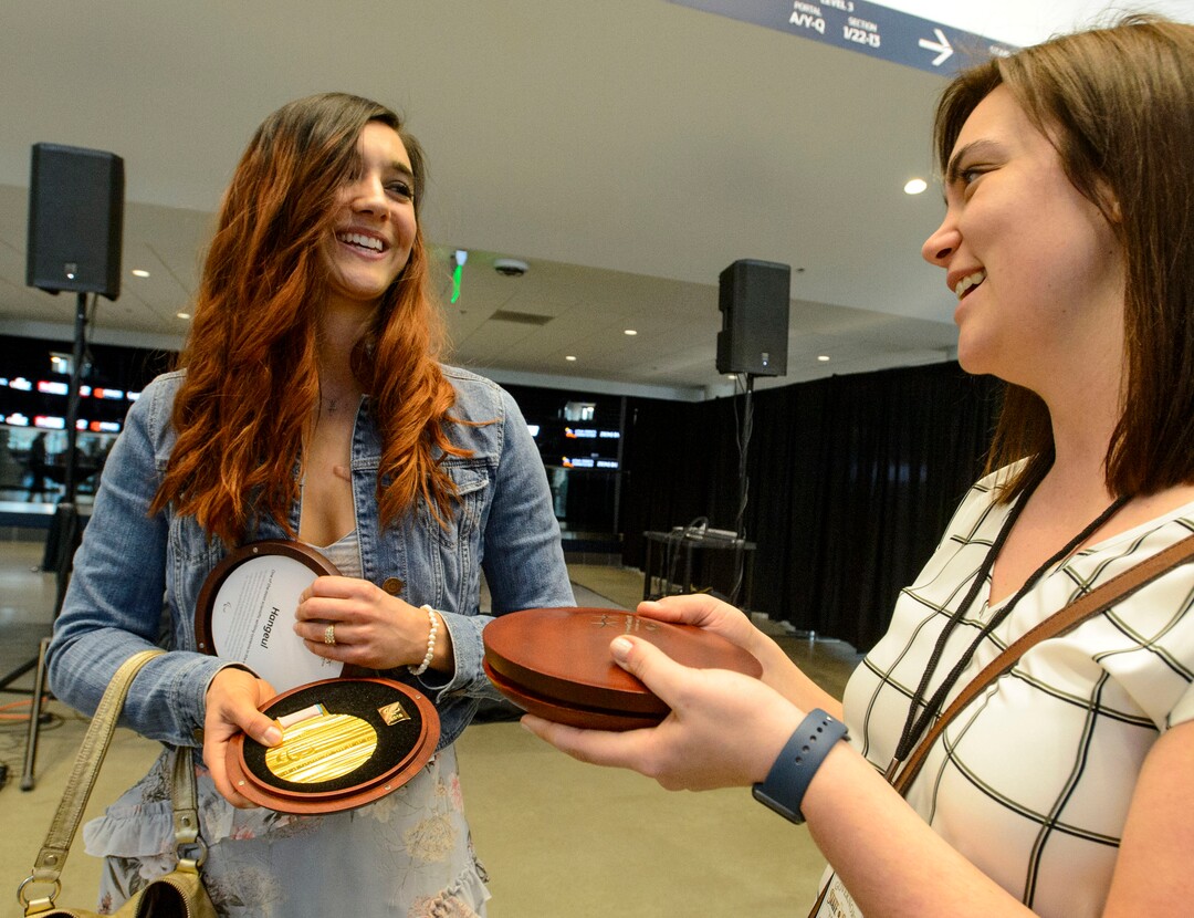 (Steve Griffin  |  The Salt Lake Tribune) 2018 Paralympic double gold medalist Brenna Huckaby, left, shows her medals to Caitlin Furin, of U.S. Ski and Snowboard, during a homecoming event for over 50 Utah connected Olympic and Paralympic athletes, prior to the seventh annual Governor's State of Sport Awards presented by Zions Bank and hosted by the Utah Sports Commission at Vivint Smart Home Arena in Salt Lake City Wednesday April 18, 2018. Huckaby won gold in the snowboard cross and banked slalom. 