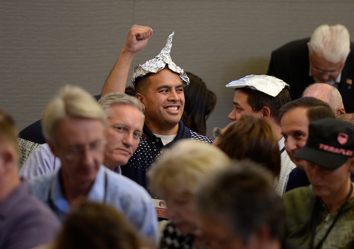 (Scott Sommerdorf | The Salt Lake Tribune)
A man celebrates after getting a tinfoil hat during a 90 minute debate over what form of voting should be used at the beginning of the Utah Republican Party Central Committee meeting, Saturday, September 9, 2017. Members were split between electronic voting, and old fashioned paper ballots. Voting using paper ballots won out after a demonstration of the electronic voting system failed.
