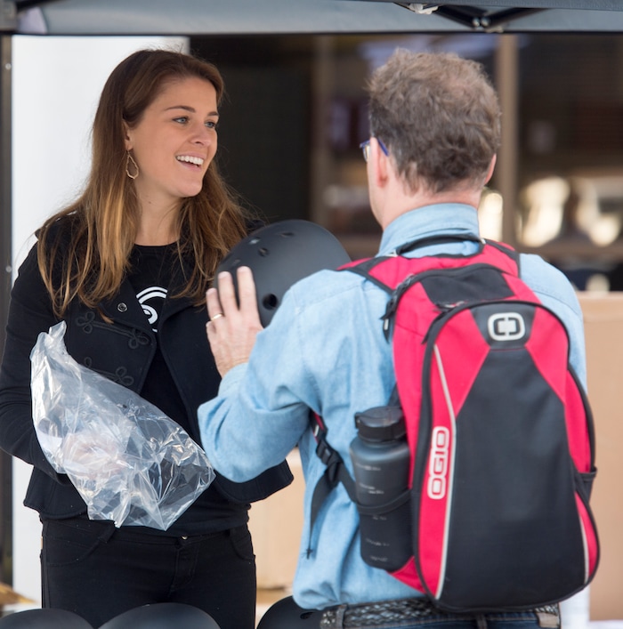 (Rick Egan  |  The Salt Lake Tribune)      Kaitlyn Murray, passes out free helmets courtesy of Bird scooters, at a news conference, about the new campaign with e-scooter companies Lime and Bird in an effort to help residents and visitors understand the rules of the sidewalk, Wednesday, Oct. 3, 2018.


