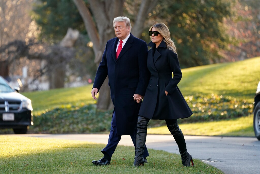 (Evan Vucci | AP file photo)  President Donald Trump and first lady Melania Trump walk to board Marine One on the South Lawn of the White House, Wednesday, Dec. 23, 2020, in Washington.