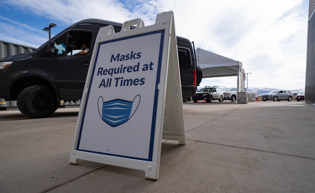 (Francisco Kjolseth  | The Salt Lake Tribune) People line up for the vaccine on Thursday, March 18, 2021, as the Utah Film Studios in Park City loans its space to the Summit County Health Department as a drive-thru COVID-19 vaccination station.