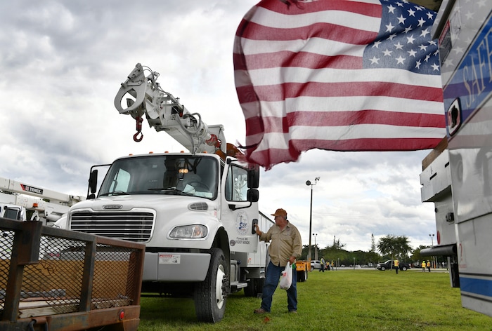 (Mike Lang | Sarasota Herald-Tribune | The Associated Press) An employee of Southern Electric Corporation from Flowood, Miss., climbs out of the cab of his truck after arriving at the Sarasota Fairgrounds Tuesday, Oct. 9, 2018. Florida Power & Light is staging their power restoration contractors in Sarasota, Fla., in advance of Hurricane Michael's expected landfall in the Florida panhandle later this week.
