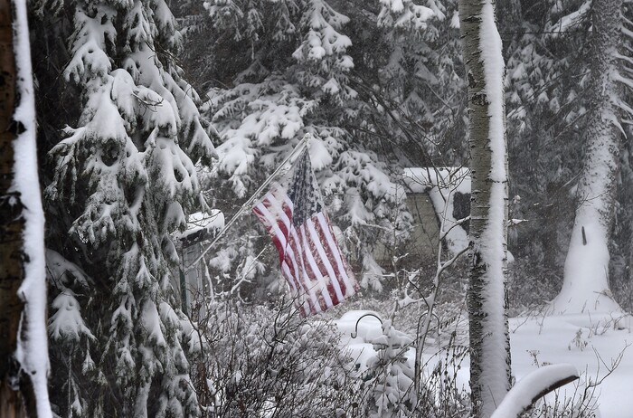 (Scott Sommerdorf   |  The Salt Lake Tribune)   A flag neglected in Big Cottonwood Canyon takes on some snow, Friday, November 17, 2017. 