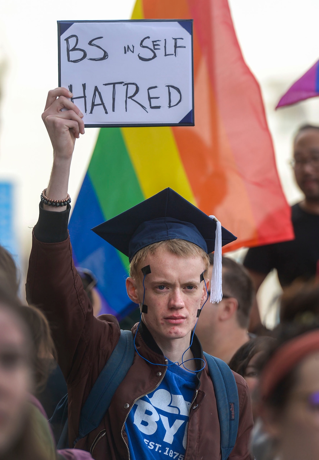 (Leah Hogsten  |  The Salt Lake Tribune) BYU alumni Devin Sudweeks taped wires to his face to resemble electrodes in reference to BYUÕs former electroshock conversion theraphy methods on LGBTQ students in the 1980s. Brigham Young University LGBTQ students took their concerns about the schoolÕs policy reversal regarding romantic behavior by same-sex couples to The Church of Jesus Christ of Latter-day Saints office building, Mar. 6, 2020. Despite removing the section on Òhomosexual behaviorÓ from BYU Honor Code last month, The LDS Church has clarified for the first time that same-sex romantic behavior is still Ònot compatibleÓ with the rules at BYU.