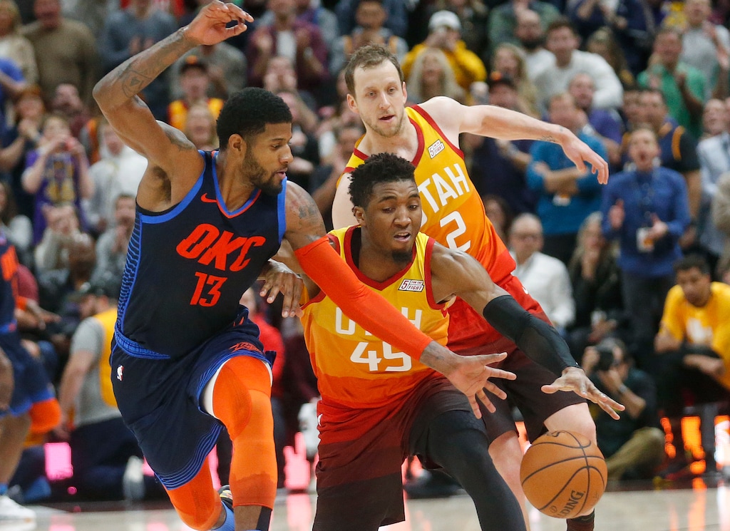 Utah Jazz guard Donovan Mitchell (45) steals the ball from Oklahoma City Thunder forward Paul George (13) in the second half during an NBA basketball game Saturday Dec. 22, 2018, in Salt Lake City. Oklahoma City won, 107-106. (AP Photo/Rick Bowmer)