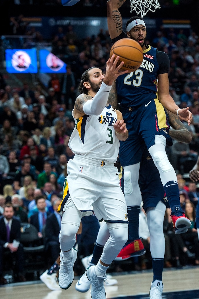 (Chris Detrick  |  The Salt Lake Tribune)  Utah Jazz guard Ricky Rubio (3) passes around New Orleans Pelicans forward Anthony Davis (23) during the game at Vivint Smart Home Arena Friday, December 1, 2017.  