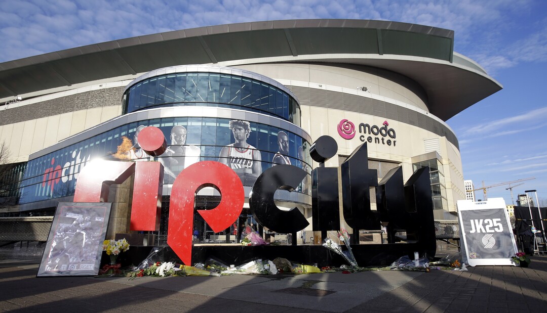 A makeshift memorial for former Portland Trail Blazer player Jerome Kersey is shown under the "rip city" sign outside the Moda Center before an NBA basketball game against the Memphis Grizzlies in Portland, Ore., Sunday, Feb. 22, 2015.  Kersey, who was part of the Trail Blazers staff,  passed away suddenly earlier this week at the age of 52. (AP Photo/Don Ryan)