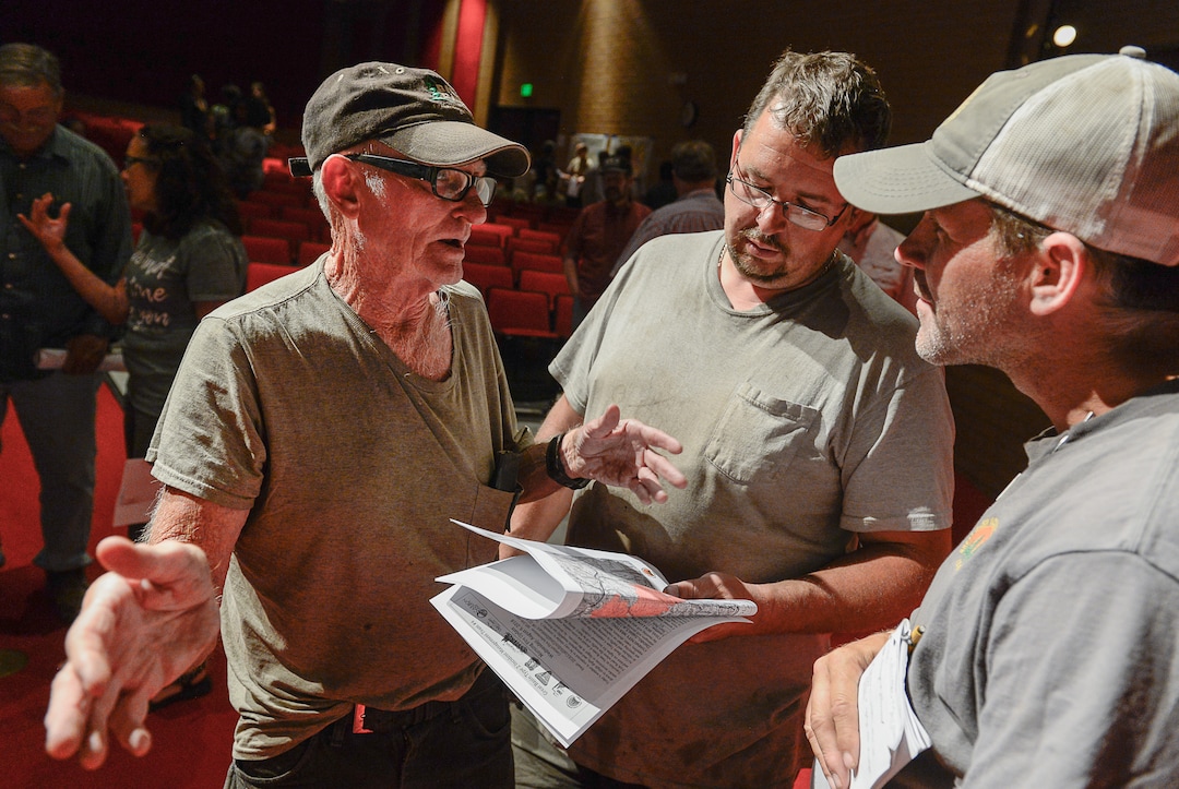 (Francisco Kjolseth  |  The Salt Lake Tribune) Glen Atwood, left, and his son Treavor speak with Operations Section Chief Dave Vining about the Coal Hollow Fire during a community meeting with the incident management team at Sanpete High School in Mt Pleasant on Thursday, Aug. 9, 2018. The Atwood's have property east of the fire line and had to evacuate.  