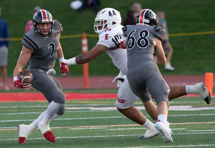(Francisco Kjolseth | The Salt Lake Tribune) Carson Tabaracci (2) of Park City looks to get past Benjamin Roberts (44) In prep football action between Park City Miners and the East Leopards on Friday, Sept. 3, 2021.