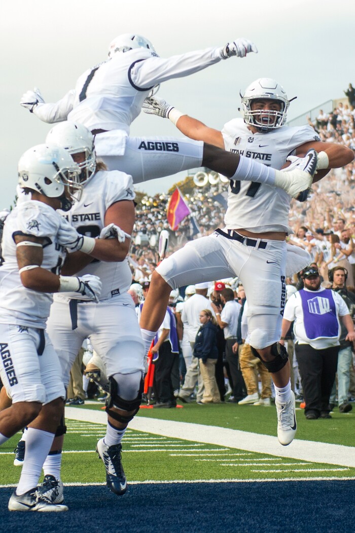 (Chris Detrick  |  The Salt Lake Tribune)  Utah State Aggies tight end Dax Raymond (87) celebrates with his teammates after scoring a touchdown during the game at Merlin Olsen Field at Maverik Stadium Friday, September 29, 2017.