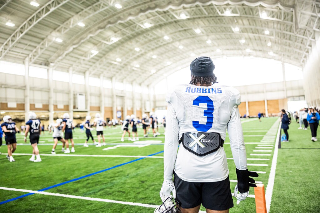 (Photography by Nate Edwards/BYU) New BYU RB Aidan Robbins looks on during practice with a brace on his right hand on 
March 15, 2023.