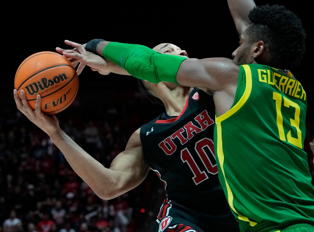 (Leah Hogsten | The Salt Lake Tribune) Utah Utes guard Marco Anthony (10) is fouled by Oregon Ducks forward Quincy Guerrier (13)as the University of Utah hosts Oregon at the Huntsman Center, Jan. 7, 2023.