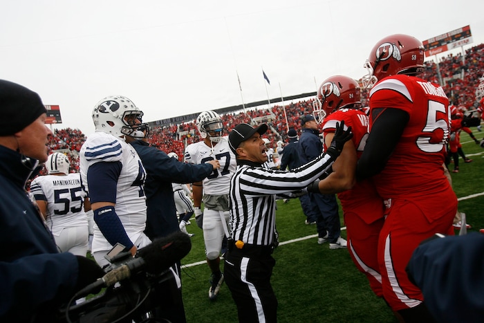 (Chris Detrick  |  Tribune file photo)  A referee breaks up a fight between Utah and BYU players before kick off as the Utes face BYU at Rice-Eccles Stadium Saturday, November 27, 2010.