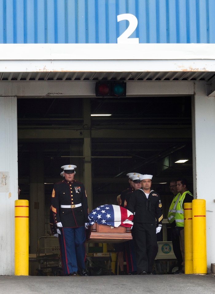 (Rick Egan  |  The Salt Lake Tribune)      The remains of Marine Pfc. Robert K. Holmes are carried from the Delta Air Cargo to a hearse for transportation to the mortuary.  Holmes died aboard the USS Oklahoma during the attack on Pearl Harbor. Friday, Aug. 17, 2018.
