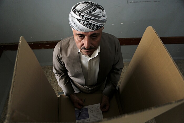 An Iraqi Kurdish man prepares casts his ballot during the referendum on independence from Iraq in Irbil, Iraq, Monday, Sept. 25, 2017. Iraq's Kurdish region vote in a referendum on whether to secede from Iraq. (AP Photo/Khalid Mohammed)