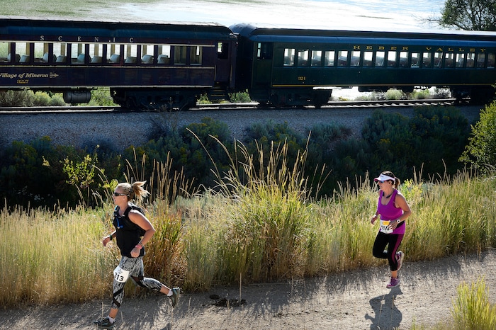 (Scott Sommerdorf | The Salt Lake Tribune) Runners race toward the finish line near the Soldier Hollow train station as they compete against the Heber Creeper train in a 12k race. The race started at the Deer Creek Dam, Saturday, August 19, 2017.