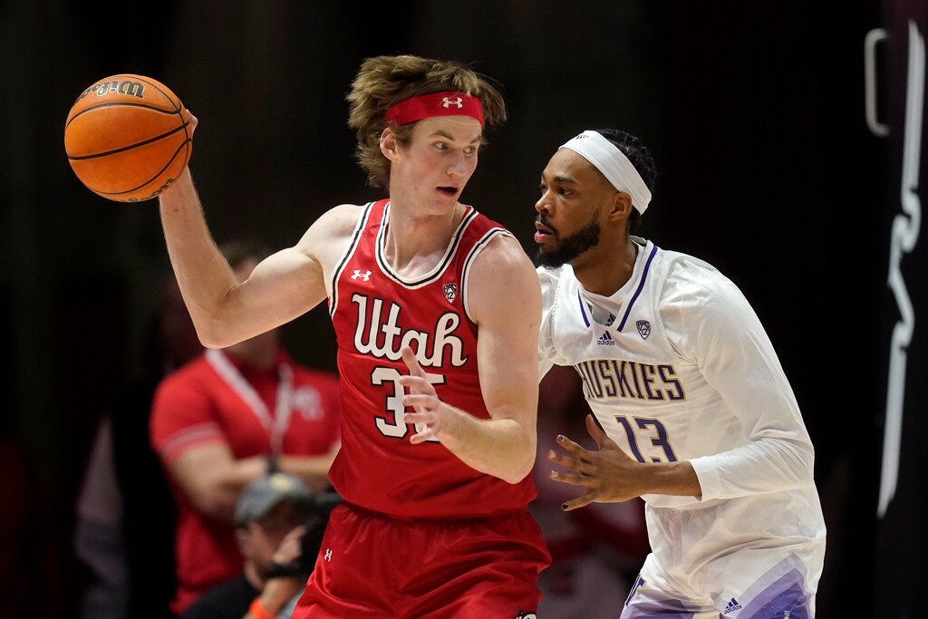 Washington forward Langston Wilson (13) guards against Utah center Branden Carlson (35) during the first half of an NCAA college basketball game Saturday, Jan. 21, 2023, in Salt Lake City. (AP Photo/Rick Bowmer)