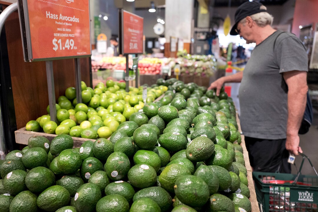 A man shops for avocados at a Whole Foods Market, Monday, Aug. 28, 2017, in New York. Amazon is moving swiftly to make big changes at Whole Foods, saying it plans to cut prices on avocados, bananas, eggs, salmon, beef and more. Amazon has completed its $13.7 billion takeover of organic grocer Whole Foods, and the e-commerce giant is wasting no time putting its stamp on the company. (AP Photo/Mark Lennihan)