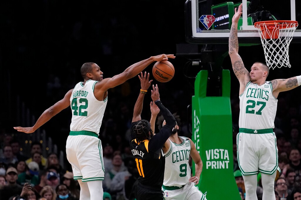 Boston Celtics center Al Horford (42) blocks a shot by Utah Jazz guard Mike Conley (11) during the second half of an NBA basketball game Wednesday, March 23, 2022, in Boston. (AP Photo/Charles Krupa)