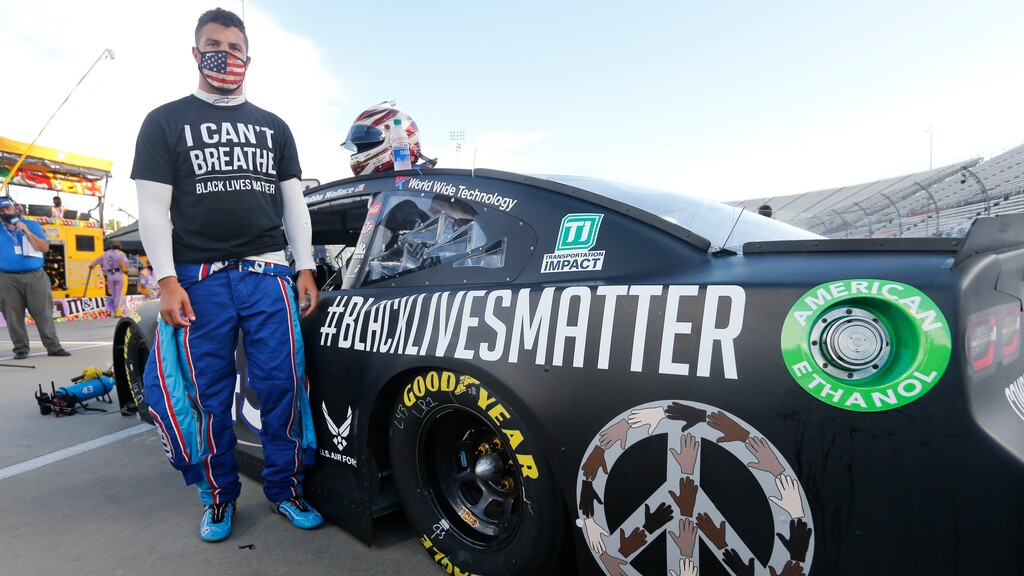 FILE - In this June 10, 2020, file photo, driver Bubba Wallace waits for the start of a NASCAR Cup Series auto race in Martinsville, Va. Bubba Wallace now counts Spike Lee and Demi Lovato – his admitted celebrity crush – as those loudly in his corner since he’s become the leader of NASCAR’s push for change. (AP Photo/Steve Helber, File)