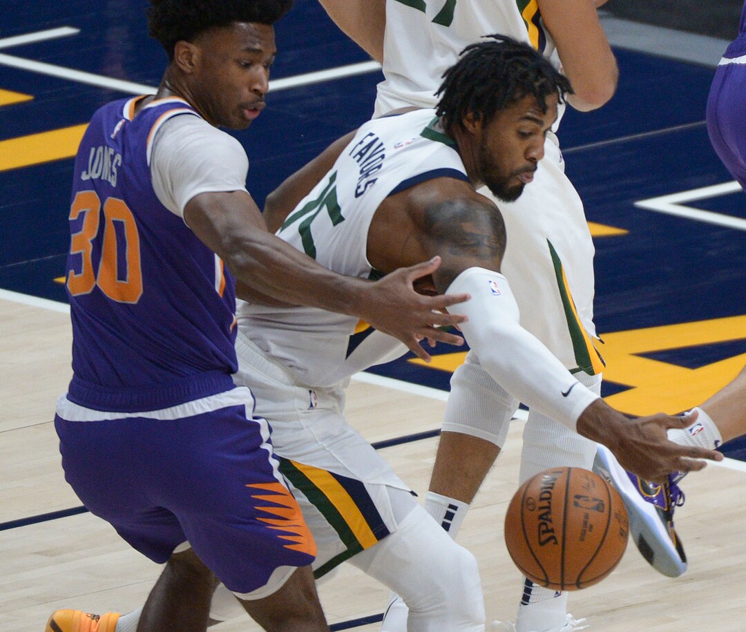(Leah Hogsten  |  The Salt Lake Tribune) Utah Jazz center Derrick Favors (15) pulls in a pass intended for Phoenix Suns center Damian Jones (30) as the Jazz crack open their 2020-21 preseason with their second game against the Phoenix Suns, Dec. 14, 2020.