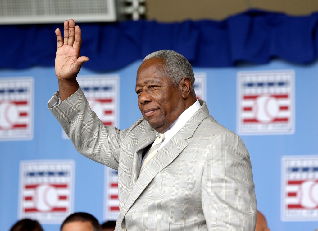 FILE - Hall of Famer Hank Aaron waves to the crowd during Baseball Hall of Fame induction ceremonies in Cooperstown, N.Y., in this Sunday, July 28, 2013, file photo. Hank Aaron, who endured racist threats with stoic dignity during his pursuit of Babe Ruth but went on to break the career home run record in the pre-steroids era, died early Friday, Jan. 22, 2021. He was 86. The Atlanta Braves said Aaron died peacefully in his sleep. No cause of death was given. (AP Photo/Mike Groll, File)