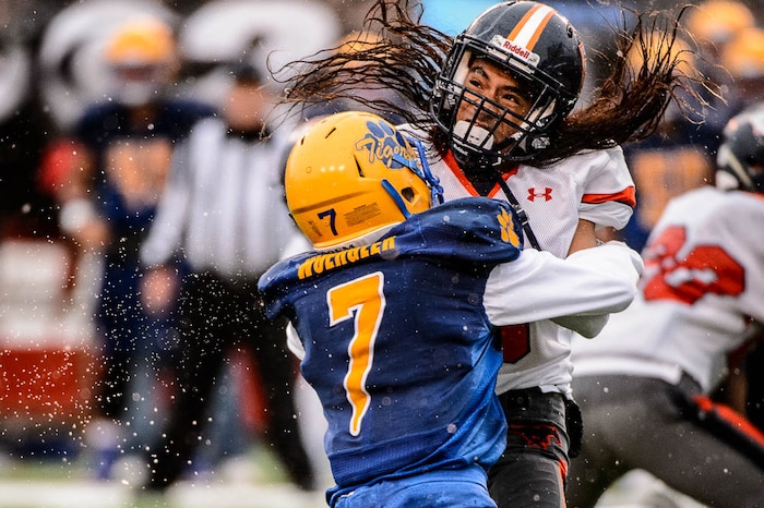 (Trent Nelson | The Salt Lake Tribune)  Mountain Crest's Lepi Taukiuvea (5) collides with Orem's Jake Wuergler (7) as Orem faces Mountain Crest in the Class 4A High School State Football Championship game in Salt Lake City, Friday November 17, 2017.