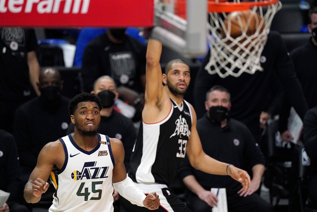 Los Angeles Clippers forward Nicolas Batum, right, scores as Utah Jazz guard Donovan Mitchell watches during the second half in Game 6 of a second-round NBA basketball playoff series Friday, June 18, 2021, in Los Angeles. (AP Photo/Mark J. Terrill)