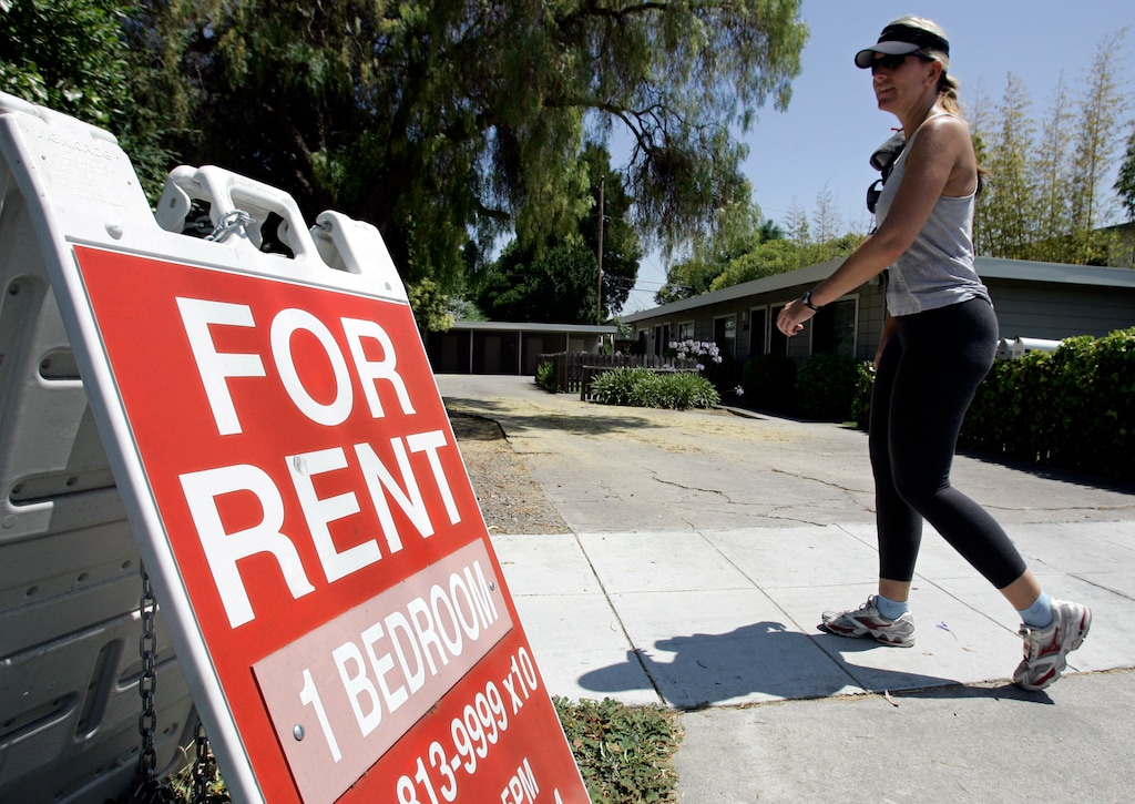 (Paul Sakuma | AP file photo) In this July 19, 2006, file photo, a woman walks next to a "For Rent" sign at an apartment complex in Palo Alto, Calif. Utah has now passed a law giving renters limited protections against undisclosed rental fees.