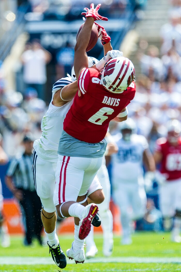 (Chris Detrick  |  The Salt Lake Tribune)   Wisconsin Badgers wide receiver Danny Davis III (6) makes a catch over Brigham Young Cougars defensive back Micah Hannemann (7) during the game at LaVell Edwards Stadium Saturday Saturday, September 16, 2017. Wisconsin Badgers are leading Brigham Young Cougars 24-6 at halftime.