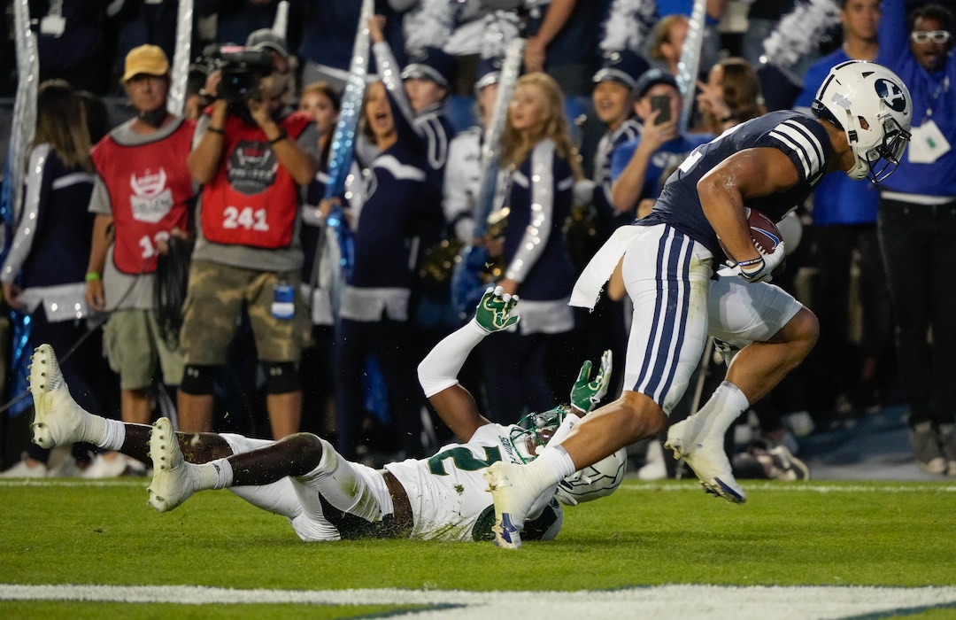 (Francisco Kjolseth | The Salt Lake Tribune)South Florida Bulls defensive back TJ Robinson (2) goes down as Brigham Young Cougars wide receiver Neil Pau'u (2) scores a touchdown in game action between the Brigham Young Cougars and the South Florida Bulls at LaVell Edwards Stadium in Provo, Saturday, Sept. 25, 2021.