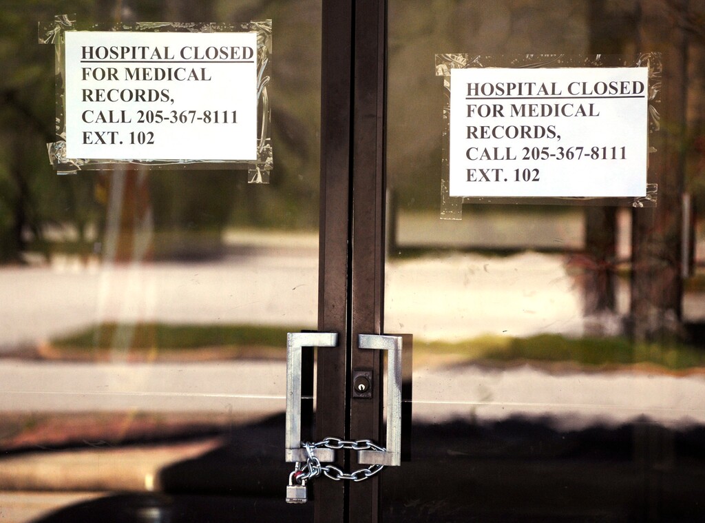 (Jay Reeves | AP file photo) Closed signs hang on a recently closed Pickens County Medical Center in Carrollton, Ala., on March 26. The hospital is one of the latest health care facilities to fall victim to a wave of rural hospital shutdowns across the United States in recent years. With hundreds of other hospitals endangered, residents are worried about getting health care amid the coronavirus outbreak, and administrators are trying to keep other facilities afloat.