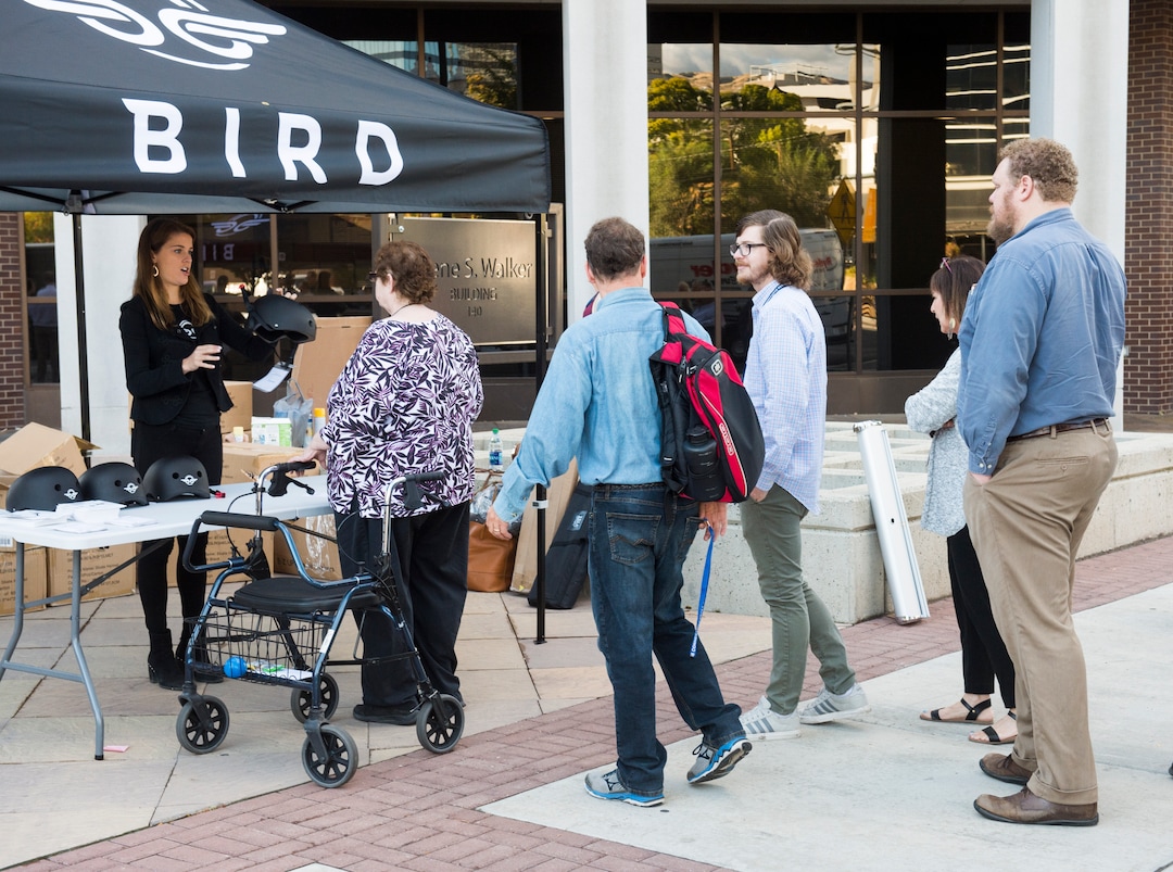 (Rick Egan  |  The Salt Lake Tribune)      People line up for free helmets courtesy of Bird scooters, after a news conference, about the new campaign with e-scooter companies Lime and Bird in an effort to help residents and visitors understand the rules of the sidewalk, Wednesday, Oct. 3, 2018.