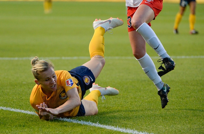 (Francisco Kjolseth  |  The Salt Lake Tribune)  Utah Royals FC hosts Washington Spirit, NWSL soccer at Rio Tinto Stadium in Sandy, Wed. Aug. 8, 2018. Utah Royals FC forward Amy Rodriguez (8) takes a tumble while defended by Washington Spirit midfielder Tori Huster (23), losing part of her shoe, during the first half of the game. 