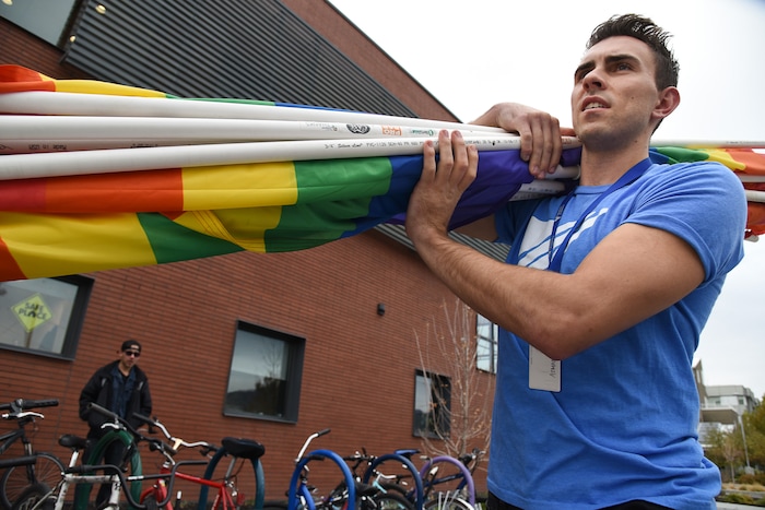 (Francisco Kjolseth | The Salt Lake Tribune) Ballet West dancer Lucas Horns gathers gay pride flags from his car as part of a service project to convert them over to transgender pride flags for the upcoming Transgender Day of Remembrance on Nov. 20. Horns who volunteers at the VOA Youth Resource Center, where he leads an LGBTQ support group, involves homeless youth through discussion and service projects. With their help Horns goal was to transfer 500 flags that would be placed from Ogden to Provo.
