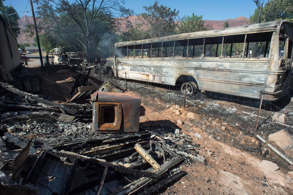 Property destroyed by Tuesday's fire is seen in Moab, Utah, Wednesday, June 13, 2018. The blaze in Moab, known for its dramatic red rocks, started in a wooded area Tuesday night and quickly spread to homes over less than a square mile, Police Chief Jim Winder said. (Rick Egan/The Salt Lake Tribune via AP)
