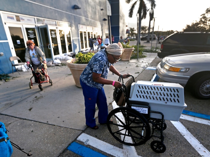 Evacuees leave the Germain Arena, which was used as an evacuation shelter for Hurricane Irma in Estero, Fla., Monday, Sept. 11, 2017. (AP Photo/Gerald Herbert)