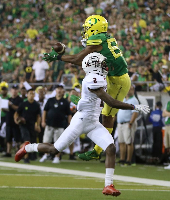 Oregon's Johnny Johnson III, top, pulls down a pass under pressure from Southern Utah's Emmanuel Roker during the third quarter of an NCAA college football game Saturday, Sept. 2, 2017, in Eugene, Ore. (AP Photo/Chris Pietsch)