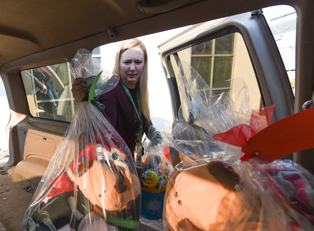 (Francisco Kjolseth  |  The Salt Lake Tribune)  Granite school district Social worker Victoria Olson fills her car with orders bound for low income children as part of the Granite Education Foundation's Santa Sacks program. A team of volunteers has been busy filling orders, helping bring some magic of the holidays to children across 60 schools in the district.
