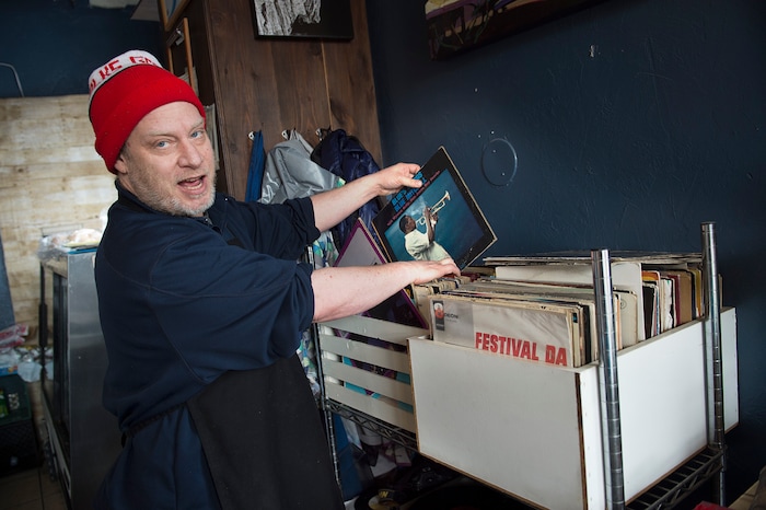 (Scott Sommerdorf   |  The Salt Lake Tribune)   The Back Door Deli co-owner Colter Wade chooses from one of the many classic jazz albums to play on the turntable.