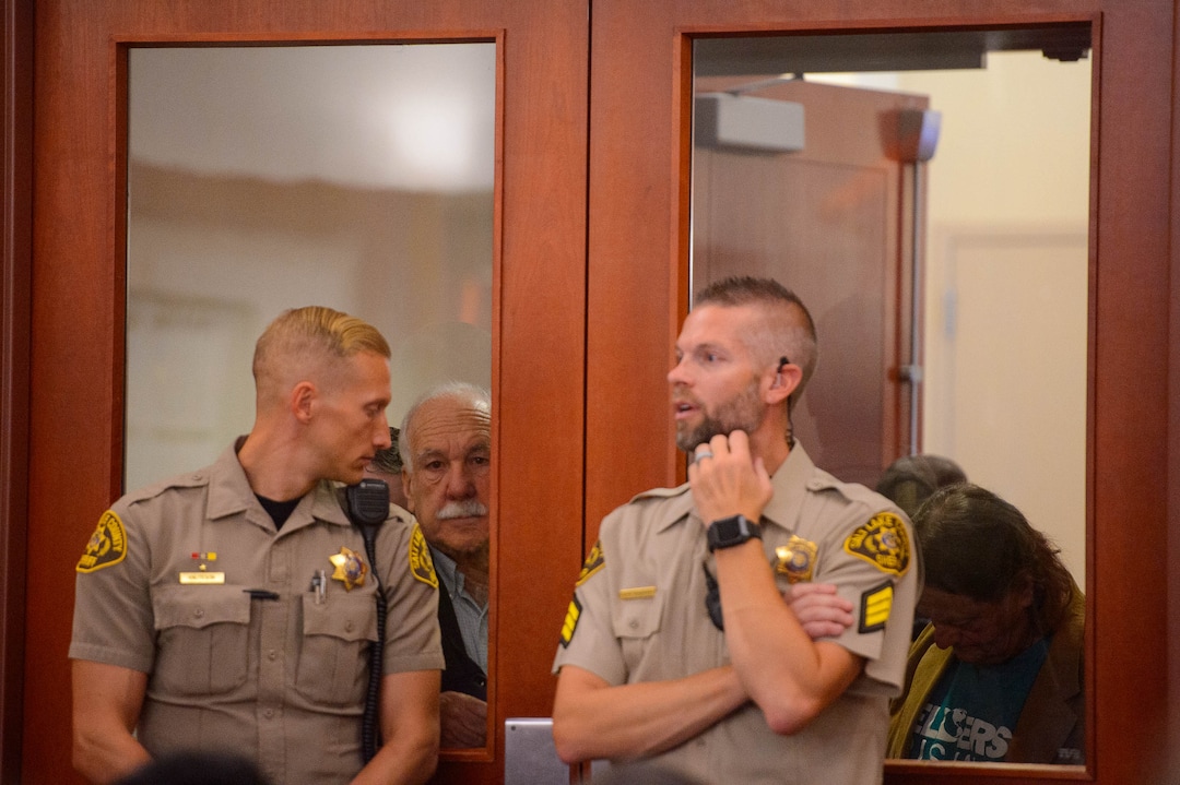 (Trent Nelson  |  The Salt Lake Tribune) Citizens look into the courtroom over the shoulders of bailiffs during a hearing on Salt Lake City’s case against the creation of the Utah Inland Port, a controversial international trading hub planned for a large swath of the municipality’s northwestern side, in Salt Lake City on Monday Nov. 18, 2019.