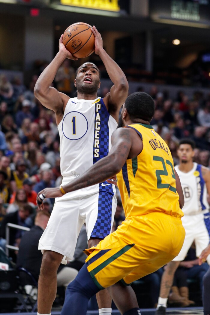 Indiana Pacers forward T.J. Warren (1) shoots over Utah Jazz forward Royce O'Neale (23) during the first half of an NBA basketball game in Indianapolis, Wednesday, Nov. 27, 2019. (AP Photo/Michael Conroy)